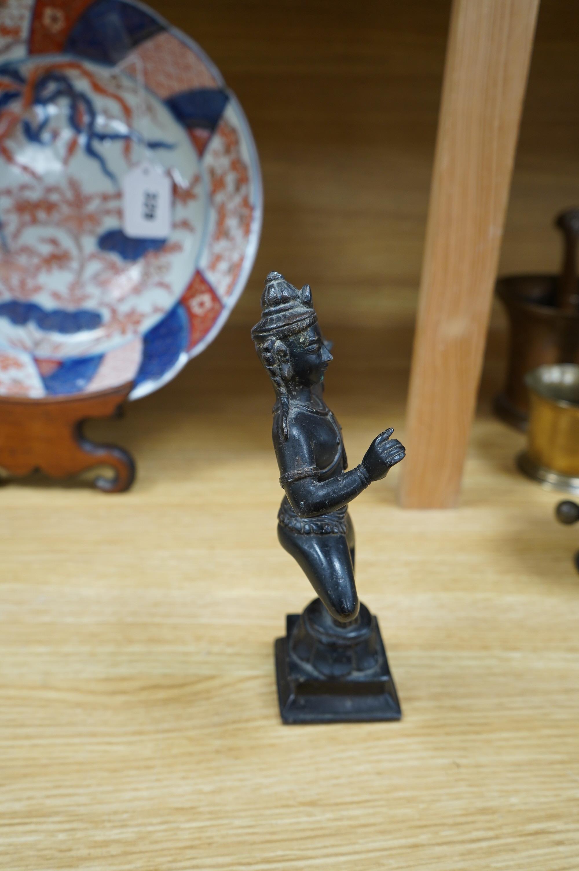 A Tibetan bronze dancing deity, 23cm high. Condition - fair